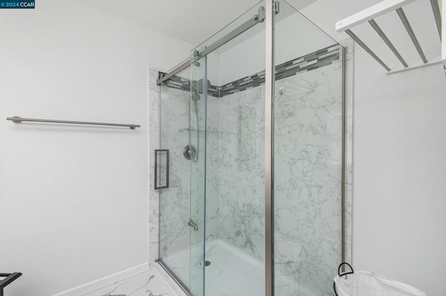 bathroom with a shower with shower door