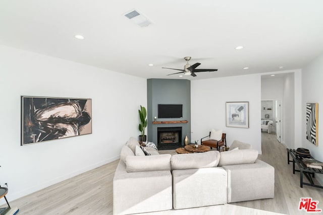 living room with light wood-type flooring and ceiling fan