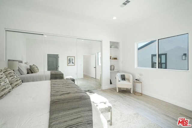 bedroom featuring light wood-type flooring and a closet