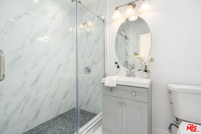 bathroom with vanity, toilet, and walk in shower