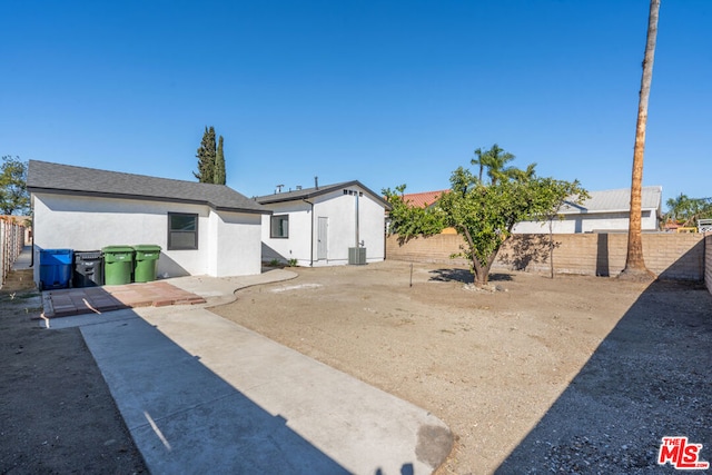 back of property featuring cooling unit and a patio area