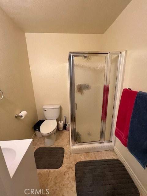 bathroom with vanity, tile patterned flooring, toilet, and walk in shower