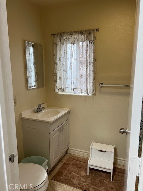 bathroom featuring vanity, toilet, and tile patterned flooring