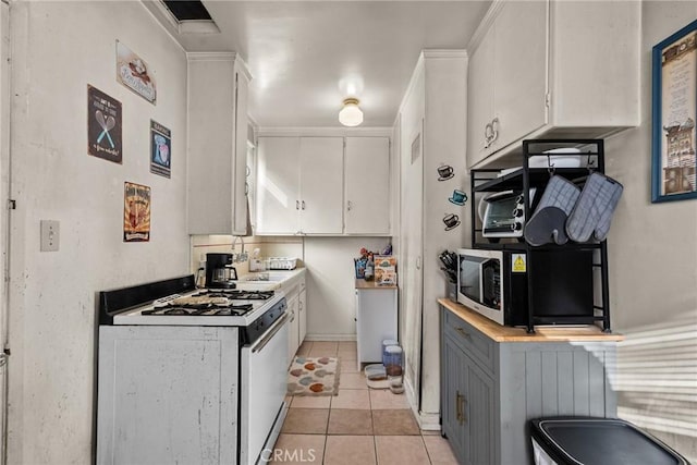 kitchen with white cabinetry, white range with gas stovetop, and light tile patterned floors