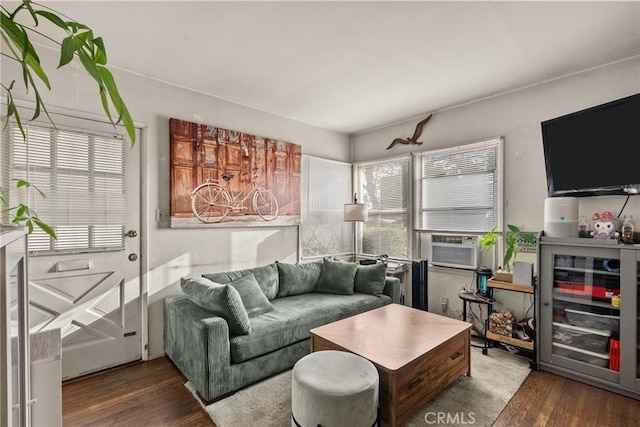 living room featuring cooling unit and dark hardwood / wood-style flooring