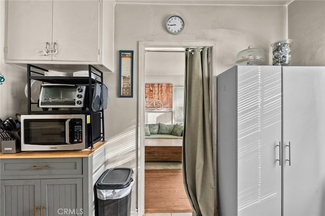 interior space with gray cabinets and hardwood / wood-style floors