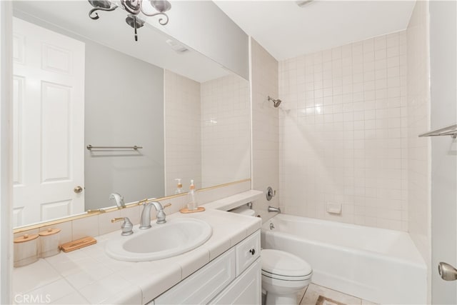 full bathroom featuring tiled shower / bath combo, tile patterned flooring, vanity, and toilet