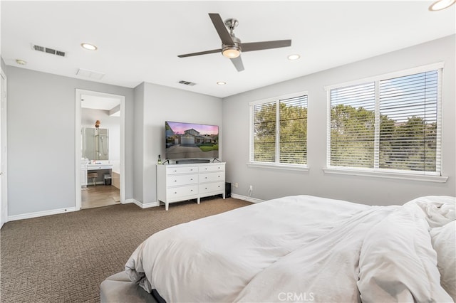 carpeted bedroom featuring ensuite bath and ceiling fan