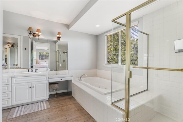 bathroom featuring hardwood / wood-style flooring, vanity, shower with separate bathtub, and plenty of natural light