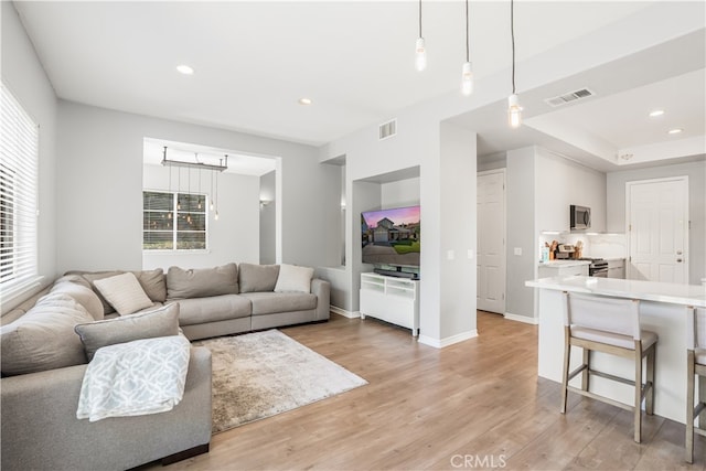 living room featuring light hardwood / wood-style flooring and plenty of natural light