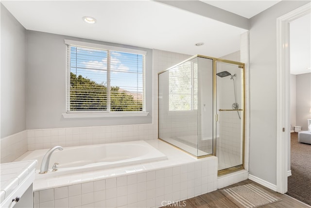 bathroom featuring separate shower and tub and hardwood / wood-style floors