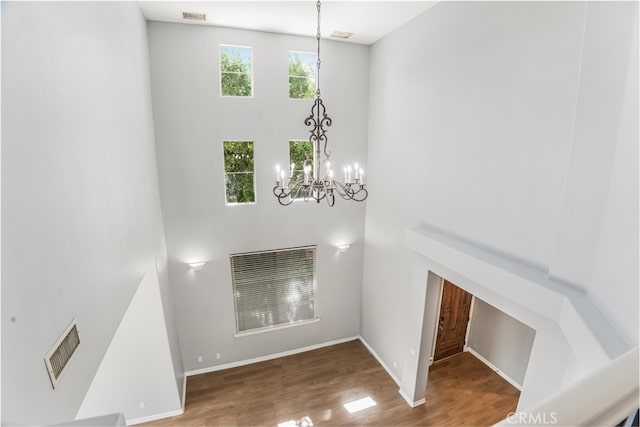 interior space featuring an inviting chandelier and wood-type flooring