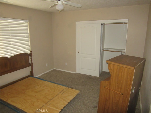 bedroom with a closet, dark colored carpet, and ceiling fan