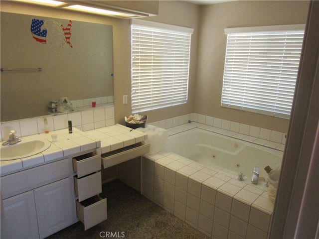 bathroom featuring vanity and a relaxing tiled tub