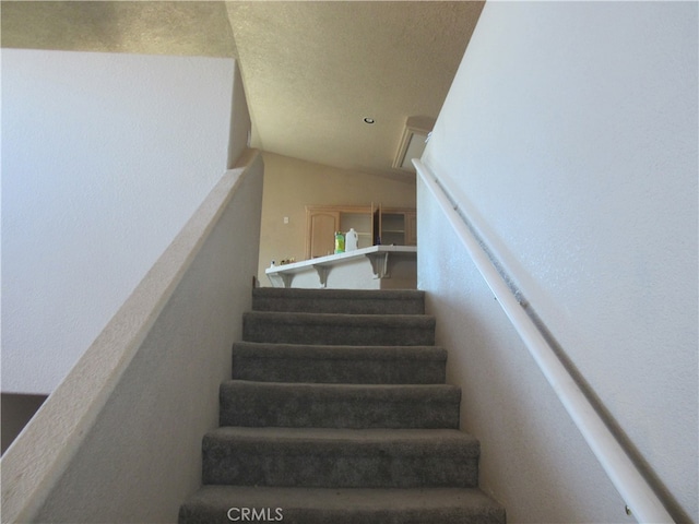 stairs with lofted ceiling