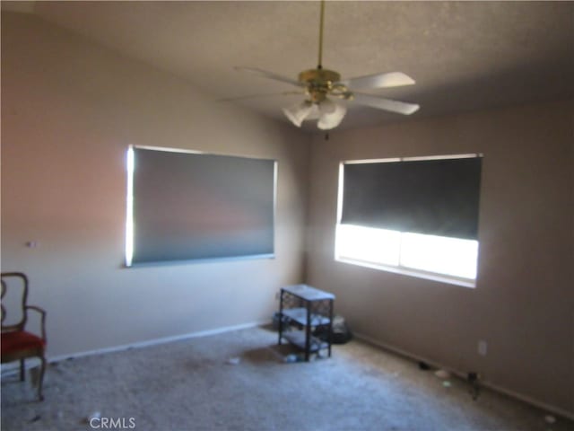 carpeted empty room with lofted ceiling and ceiling fan