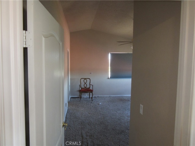 hall featuring carpet floors and vaulted ceiling