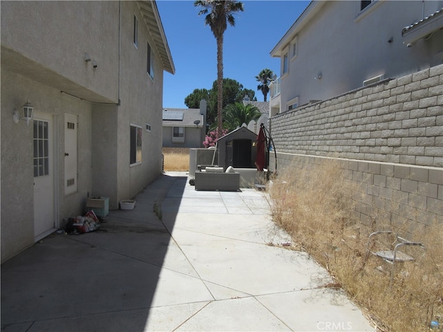 view of patio / terrace with a shed