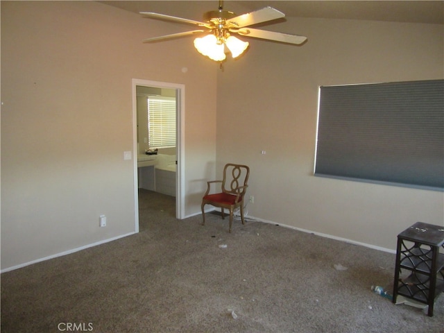 unfurnished room with dark colored carpet, lofted ceiling, and ceiling fan