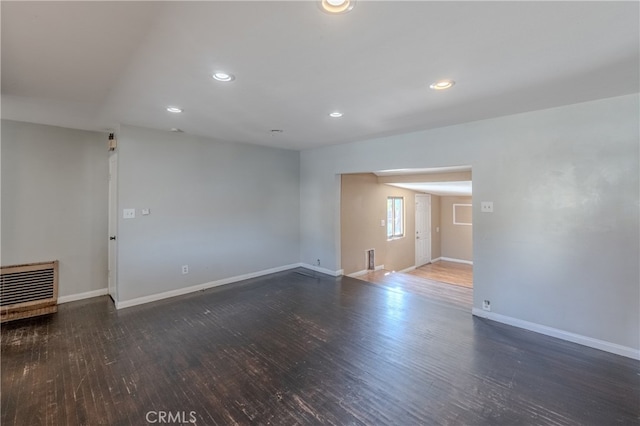 empty room with dark wood-type flooring