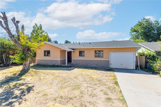 ranch-style home with a front lawn and a garage