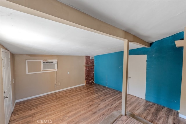 interior space with hardwood / wood-style floors and a wall unit AC