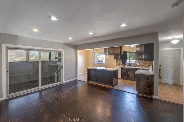 kitchen featuring dark hardwood / wood-style flooring, a wealth of natural light, and a kitchen island