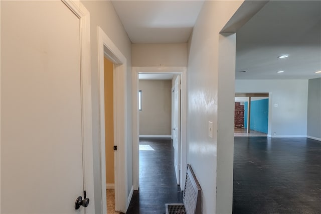 corridor featuring dark wood-type flooring