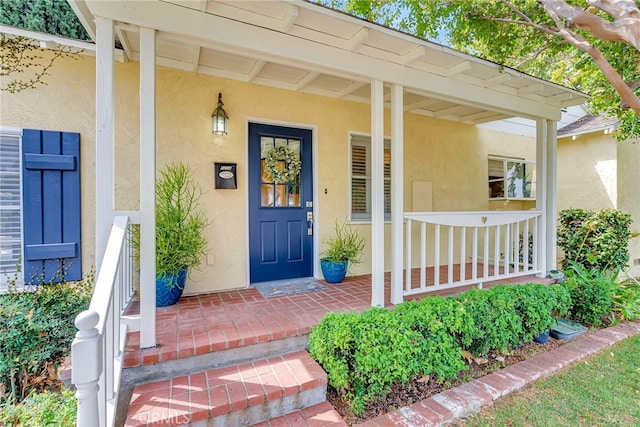 view of exterior entry with covered porch