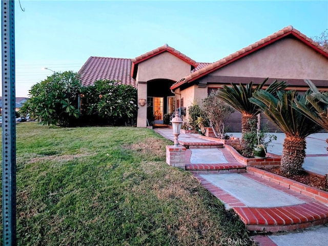 mediterranean / spanish-style house featuring a front yard