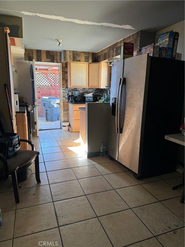 kitchen featuring stainless steel fridge with ice dispenser, light tile patterned flooring, and light brown cabinetry