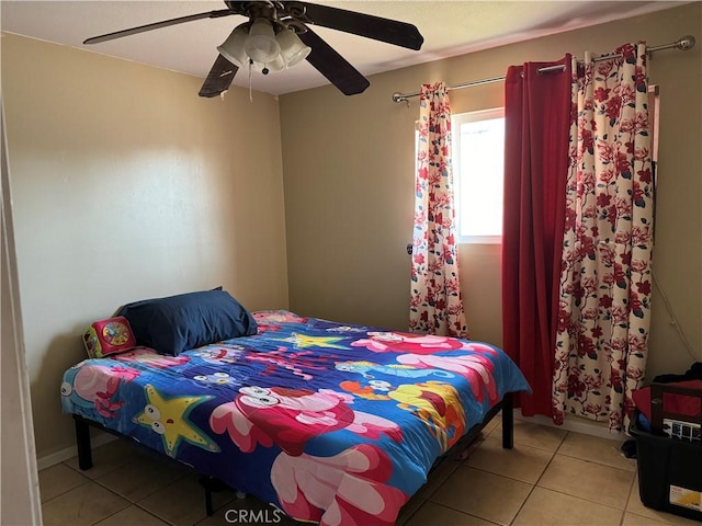 tiled bedroom featuring ceiling fan