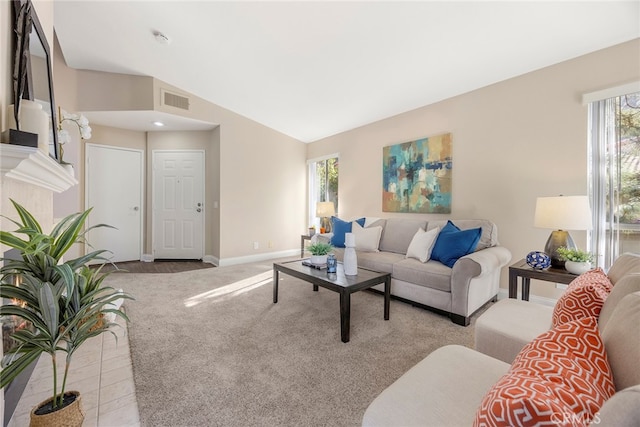 carpeted living room featuring vaulted ceiling