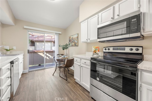 kitchen featuring sink, dark wood-type flooring, stainless steel appliances, and white cabinets