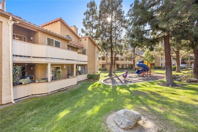 view of property's community with a lawn and a patio area