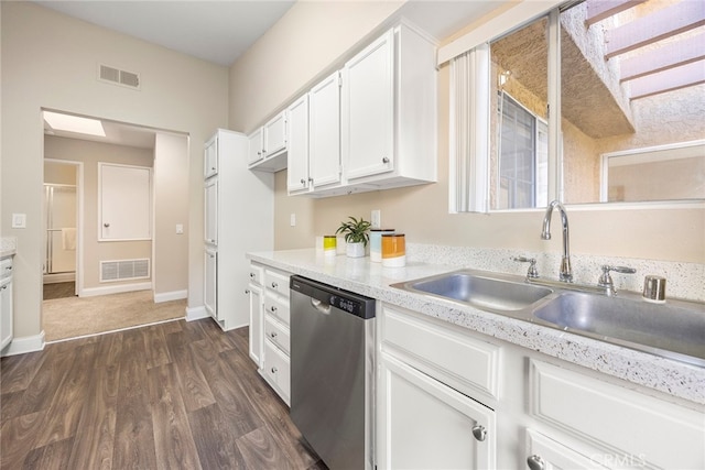 kitchen with dark hardwood / wood-style floors, dishwasher, sink, and white cabinets