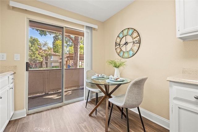 dining space with light wood-type flooring