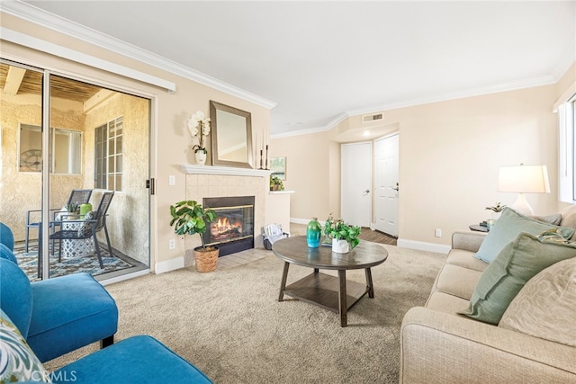 carpeted living room featuring ornamental molding and a tiled fireplace