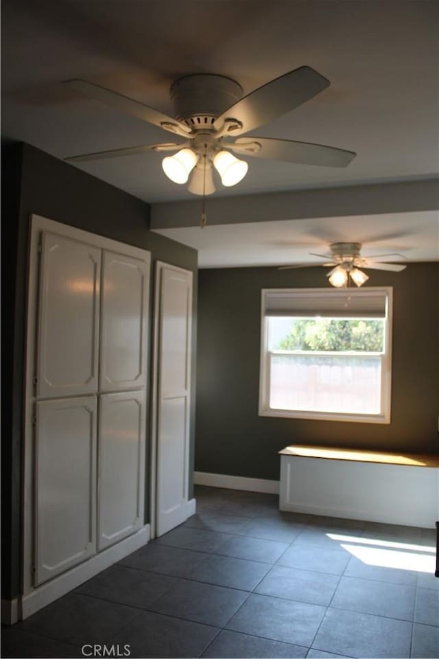924 Oleander St, Brea, CA 92821 - unfurnished bedroom with dark tile patterned flooring, ceiling fan, and a closet