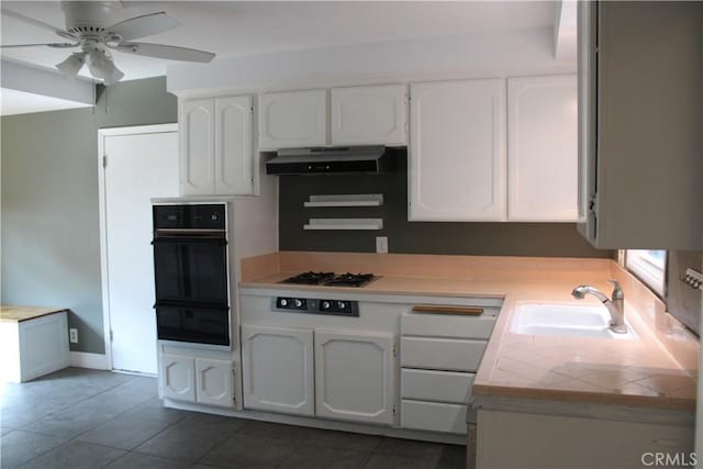 924 Oleander St, Brea, CA 92821 - kitchen with oven, a warming drawer, stainless steel gas stovetop, under cabinet range hood, and tile counters