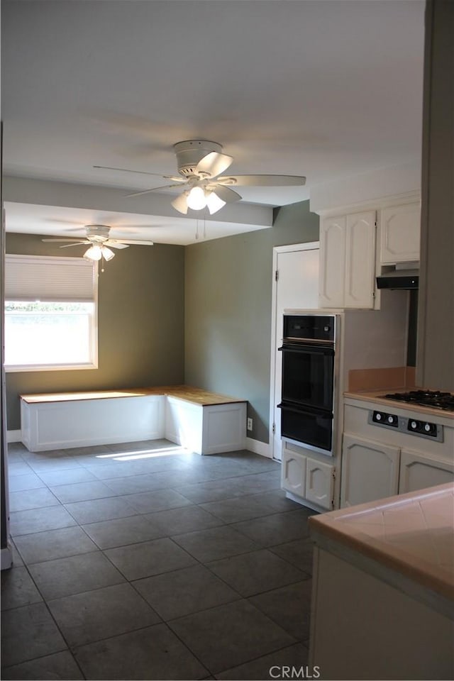 924 Oleander St, Brea, CA 92821 - kitchen with a warming drawer, oven, gas cooktop, white cabinets, and under cabinet range hood