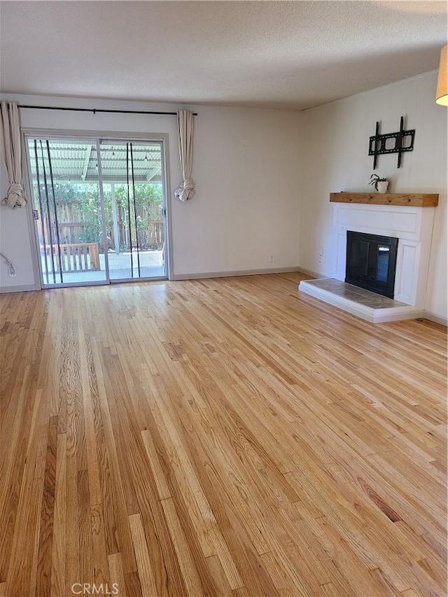 924 Oleander St, Brea, CA 92821 - unfurnished living room with wood finished floors, a glass covered fireplace, and a textured ceiling