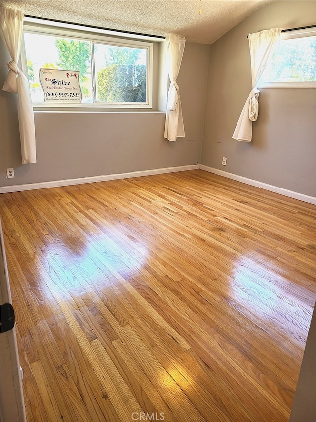924 Oleander St, Brea, CA 92821 - empty room with wood finished floors and a textured ceiling