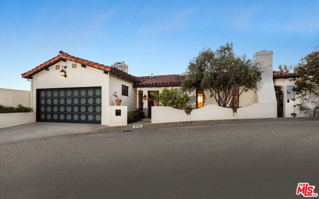 mediterranean / spanish house featuring a garage