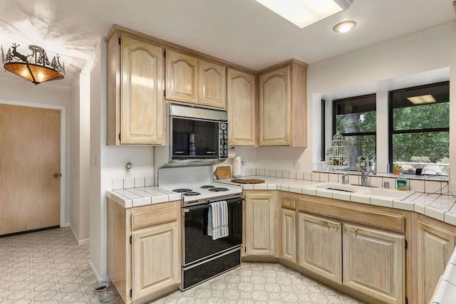 kitchen featuring sink, tile countertops, light brown cabinetry, and electric stove