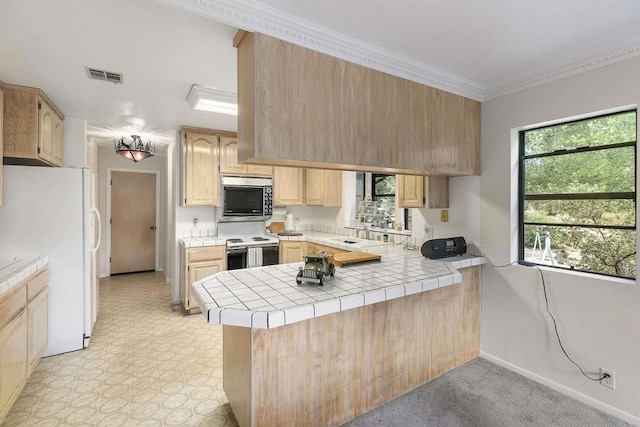 kitchen featuring range with electric stovetop, white refrigerator, tile counters, kitchen peninsula, and light brown cabinets