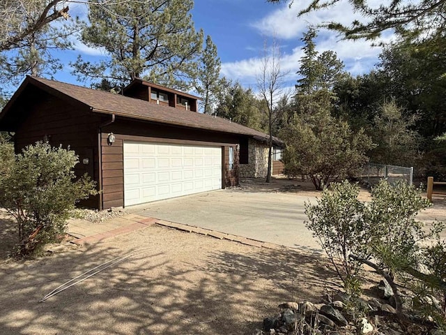 view of home's exterior featuring driveway and a garage