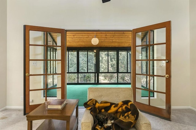 doorway featuring baseboards and carpet floors