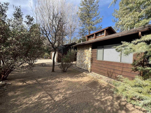 view of side of property featuring stone siding