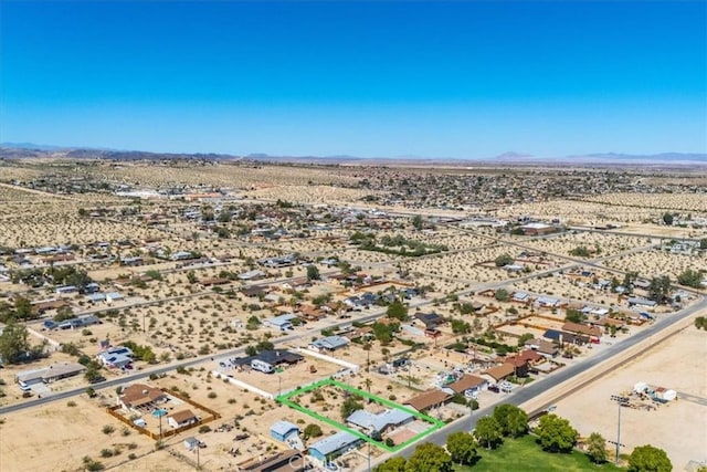 6818 El Sol Ave Unit 29, Palms, CA 92277 - aerial view of sparsely populated area featuring a desert landscape, a mountainous background, and property parcel outlined